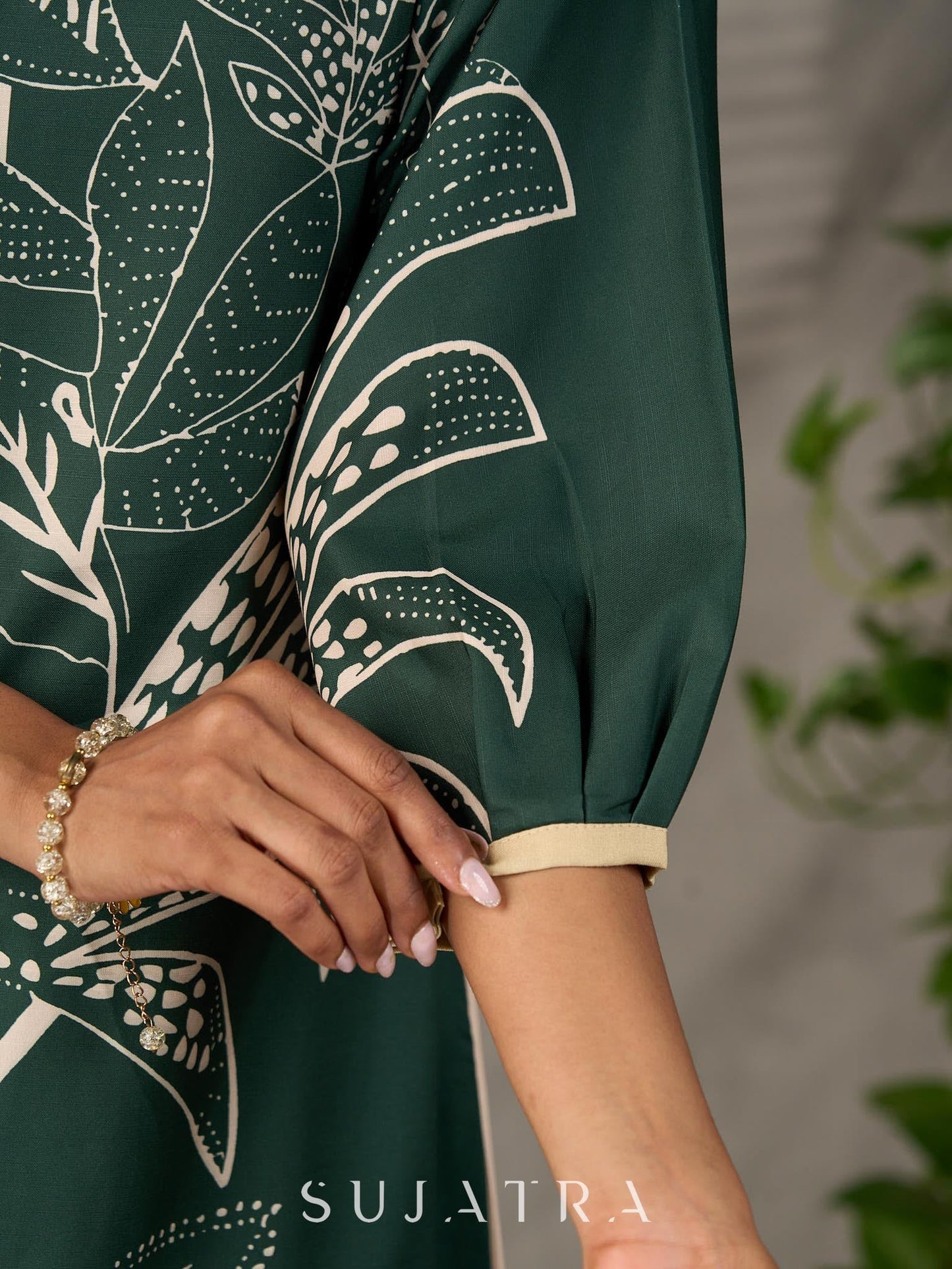 Bottle green and beige half and half dress with raglan sleeves and transitioning floral motifs.