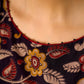 Mustard Kalamkari dress with an asymmetrical yoke and puffed sleeves.