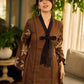 Brown block print dress with floral block printed flared sleeves, black tie-up neckline, and contrast black accents for an effortless, elegant everyday look.