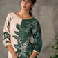 Bottle green and beige half and half dress with raglan sleeves and transitioning floral motifs.