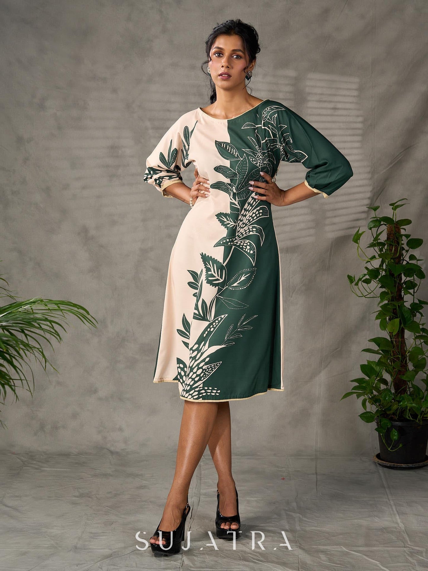 Bottle green and beige half and half dress with raglan sleeves and transitioning floral motifs.