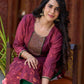 Exquisite deep burgundy printed kurta with intricate neck panel embroidery, delicate green beads, and refined green highlights.