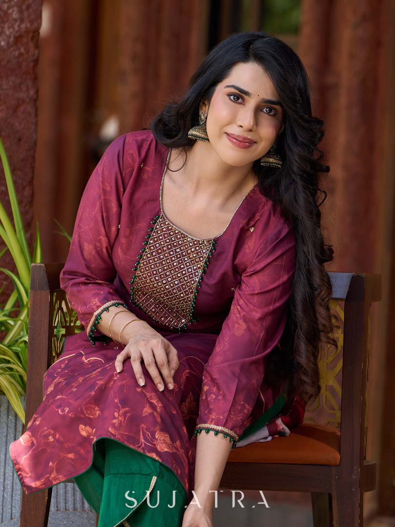 Exquisite deep burgundy printed kurta with intricate neck panel embroidery, delicate green beads, and refined green highlights.