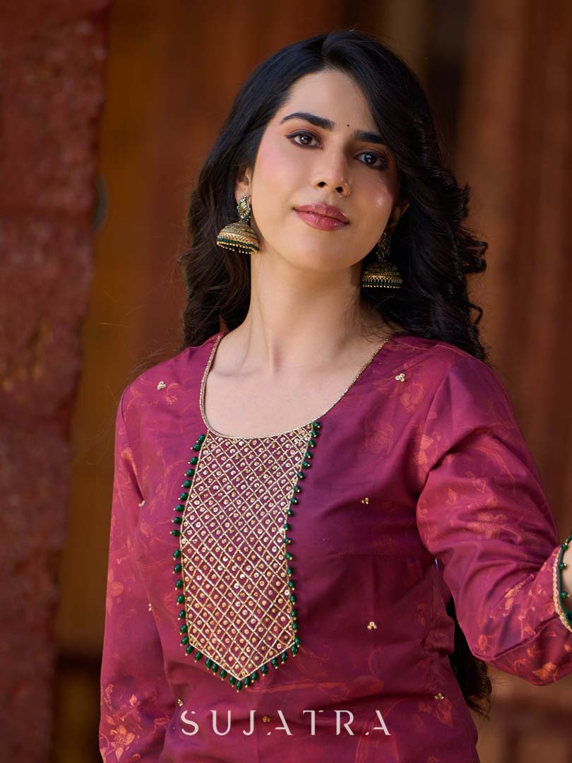 Exquisite deep burgundy printed kurta with intricate neck panel embroidery, delicate green beads, and refined green highlights.
