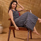 Textured grey Jamdani sleeveless waistcoat with bold red accents and an asymmetrical opening, creating a sharp, modern silhouette with distinctive, fashion-forward appeal.