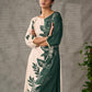 Bottle green and beige half and half dress with raglan sleeves and transitioning floral motifs.
