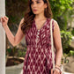 Statement maroon Ikat sleeveless dress elevated with pintuck detailing through the bodice and box pleats beyond the darts for a soft, flowing finish.