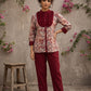 Elegant maroon floral top with intricate maroon pleats, high neckline, covered buttons, and coordinating sleeve cuffs.