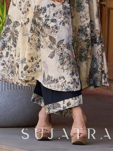 Elegant black–white floral kurta featuring a graceful bias silhouette, intricate mirror embroidery on the neck and sleeves, and a sweetheart neckline.