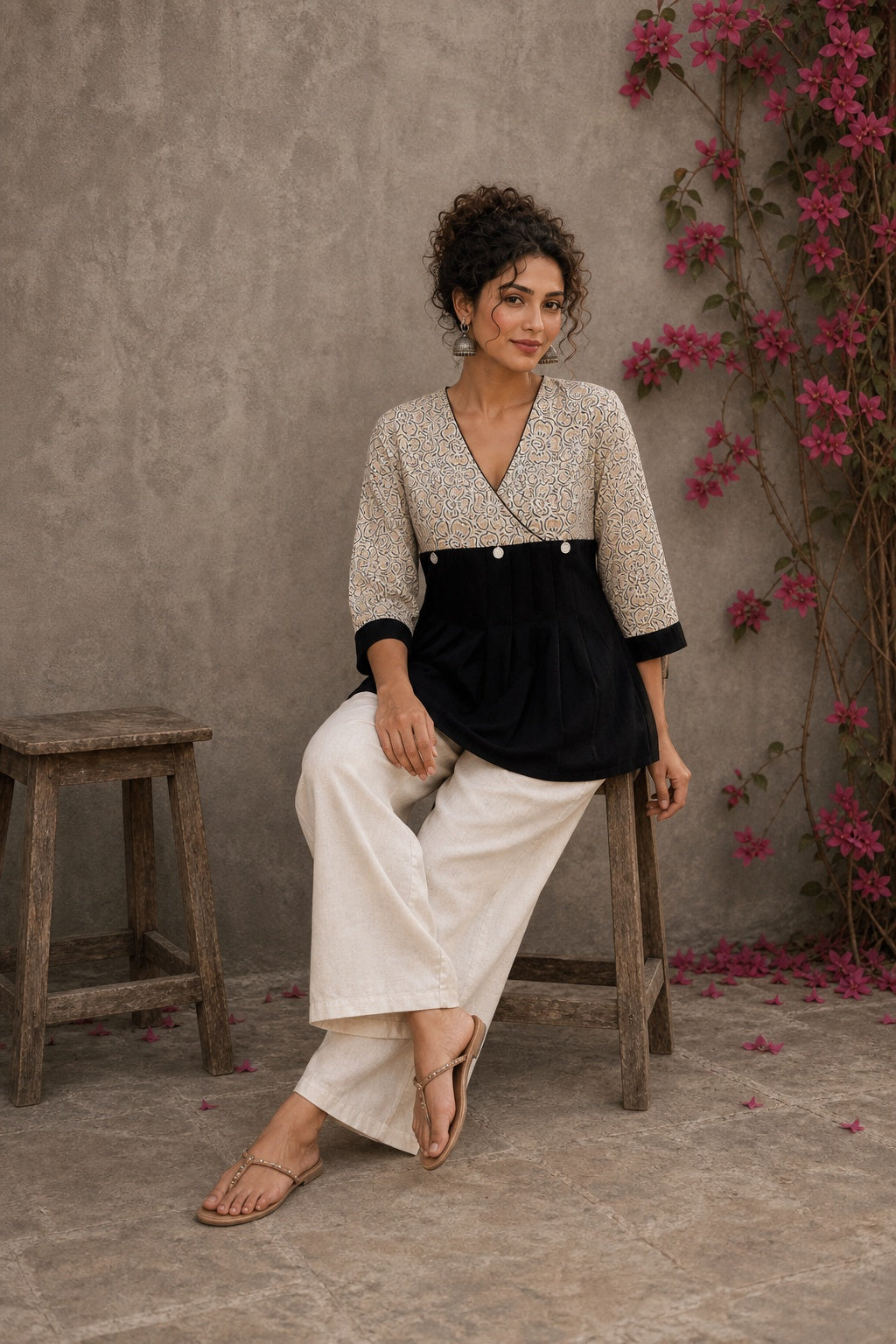 Black Jaipur floral printed yoke top featuring black pintuck body, three-quarter sleeves, and delicate ruffled sleeve edging.