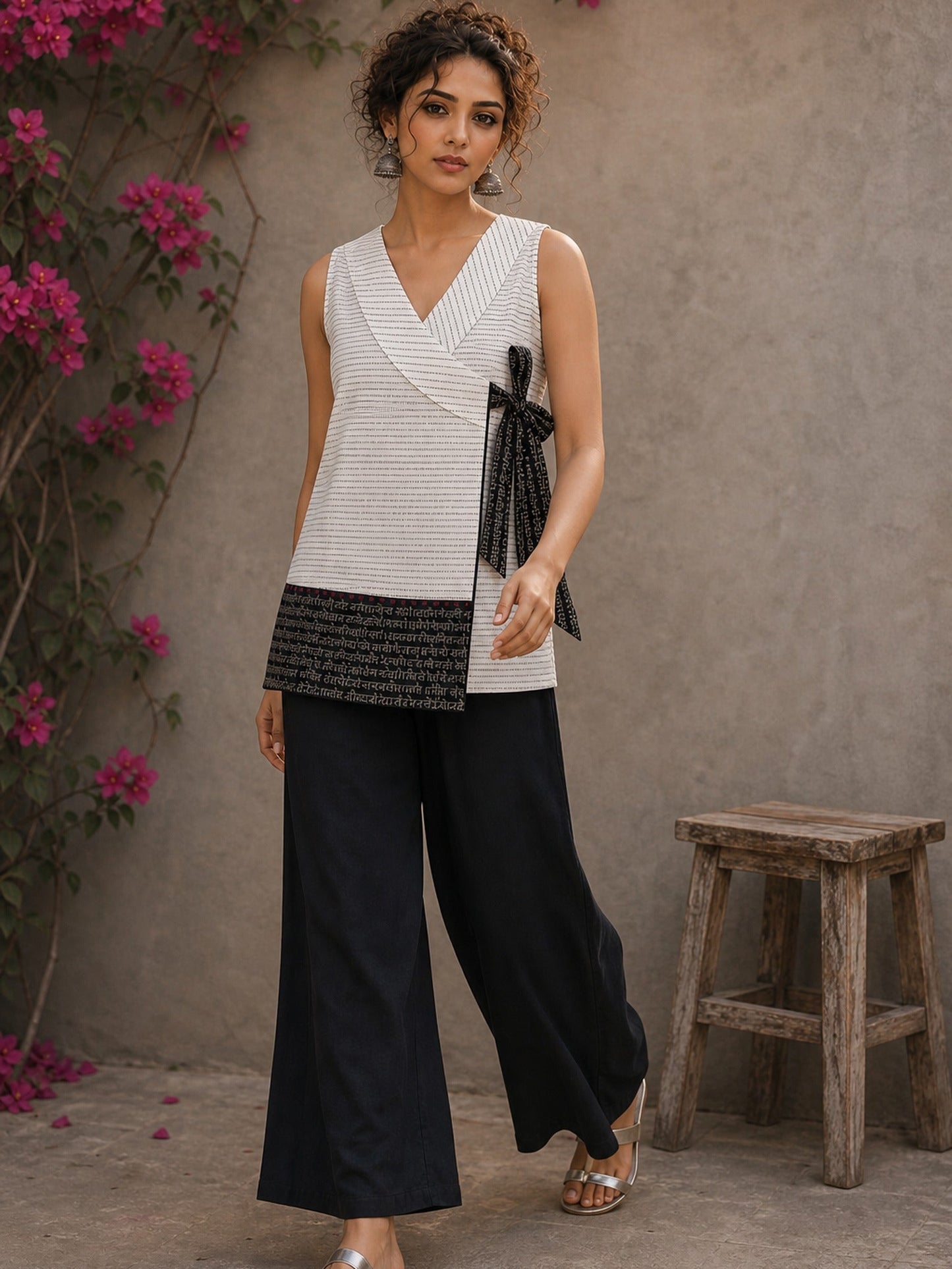 White cotton wrap-style top featuring contrast block print mantra borders, side tie, and modern silhouette.