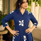 Navy blue apple-cut shirt dress with white floral hand block motifs, conceptually placed and finished with clean white edging and red accents for a refined, contemporary look.