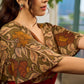 Elegant maroon dress featuring an attached artisan Kalamkari shoulder cape.