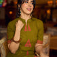 Gorgeous olive dress with pink abstract triangle hand block prints placed at the centre, sleeves, and back, featuring a mandarin collar and half sleeves for a refined, contemporary look.