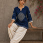 Captivating navy top adorned with a bold, rhythmic block print design, pleated sleeve detailing, and a versatile cut.
