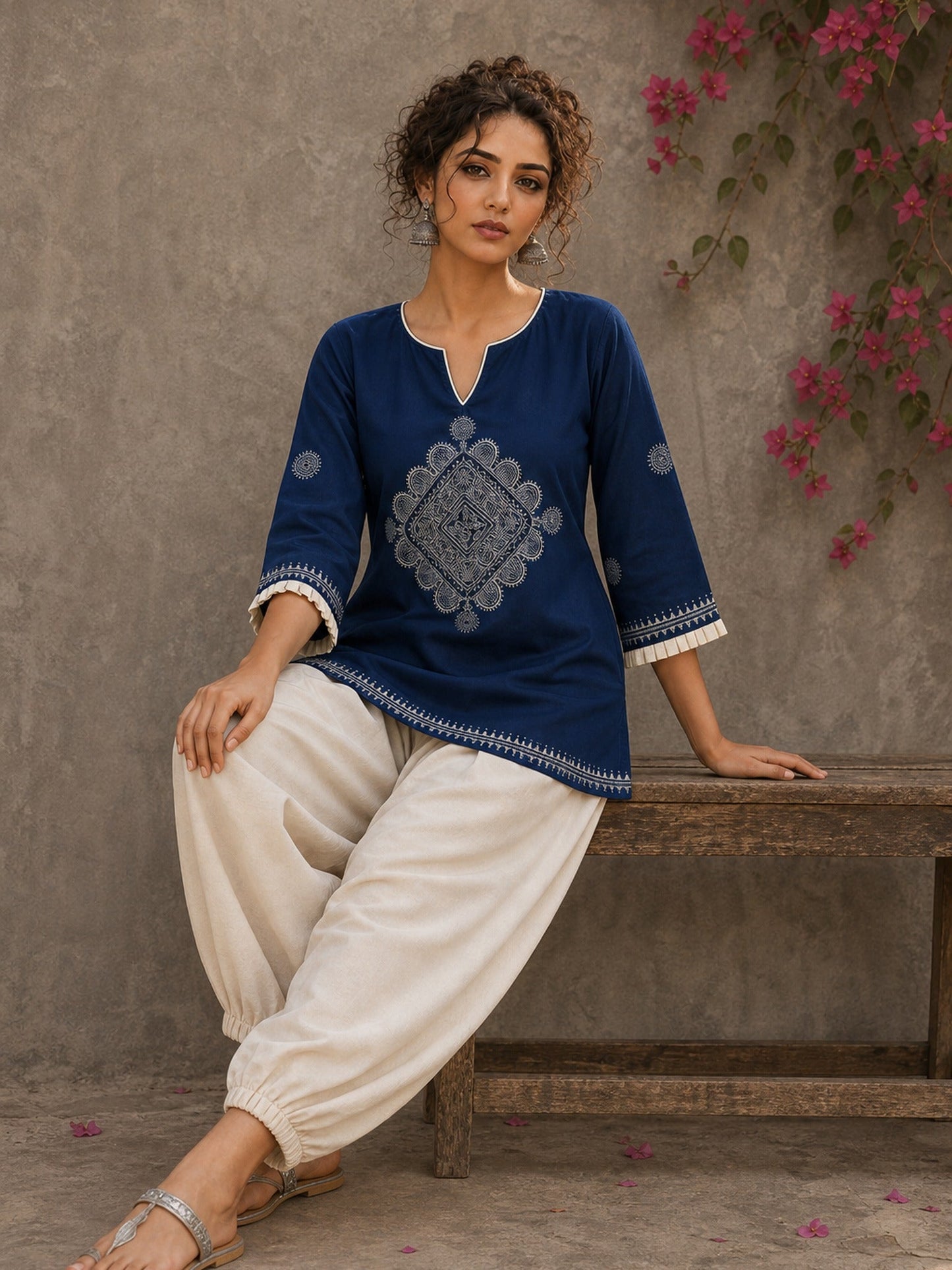 Captivating navy top adorned with a bold, rhythmic block print design, pleated sleeve detailing, and a versatile cut.