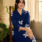 Navy blue apple-cut shirt dress with white floral hand block motifs, conceptually placed and finished with clean white edging and red accents for a refined, contemporary look.