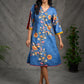 Indigo Kalamkari printed dress with vibrant red and mustard accents.