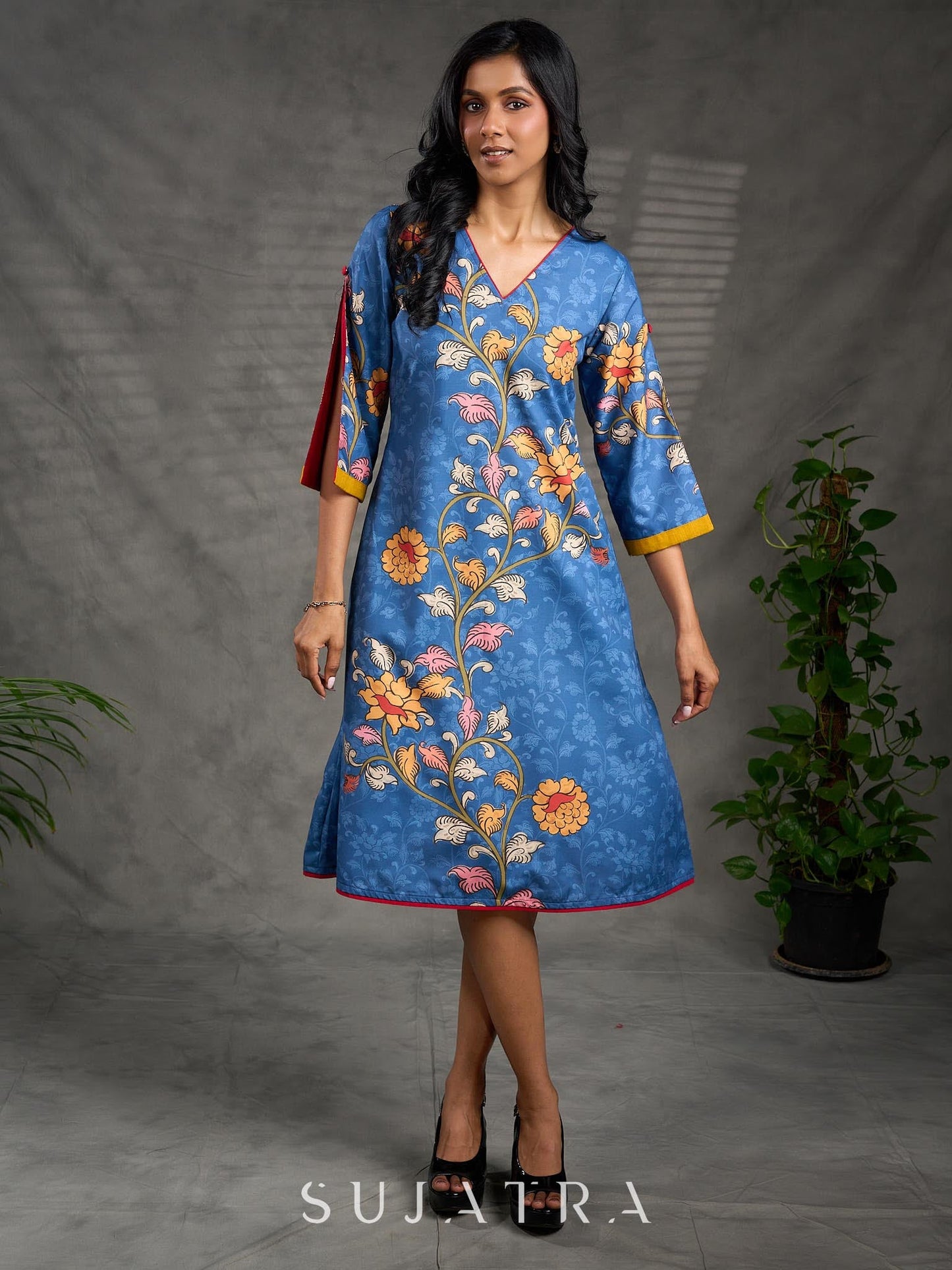Indigo Kalamkari printed dress with vibrant red and mustard accents.