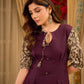 Playful purple cotton dress showcasing floral puff sleeves and box pleats released from the dart for soft volume and flow