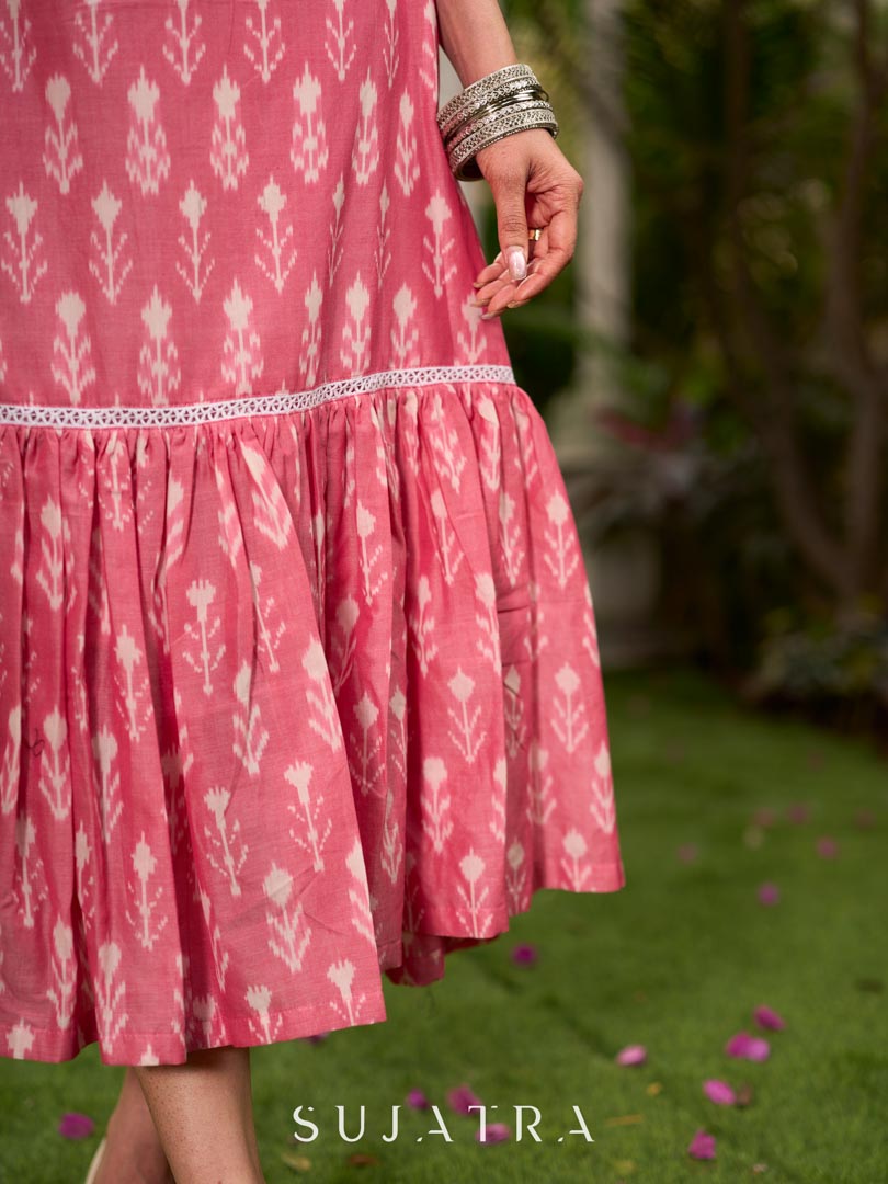 Graceful pink Ikat long dress accented in white, designed with gathered detailing at the fall and a clean sleeveless finish