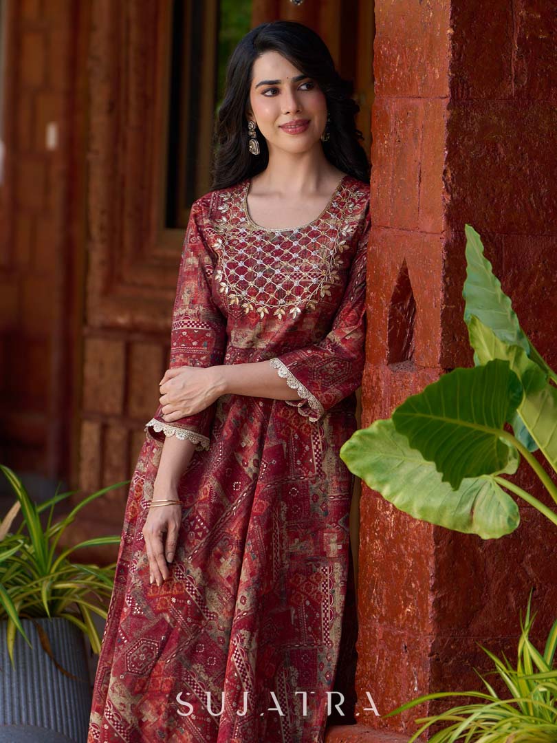 Exquisite deep maroon printed kurta with a graceful bias silhouette, intricate handwork on the yoke, and scalloped sleeve detailing.