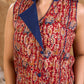 Sharp sleeveless red Kalamkari overlap jacket with a statement one-sided flap, Chinese collar, and navy accents, offering a clean, structured silhouette ideal for elevated corporate styling.