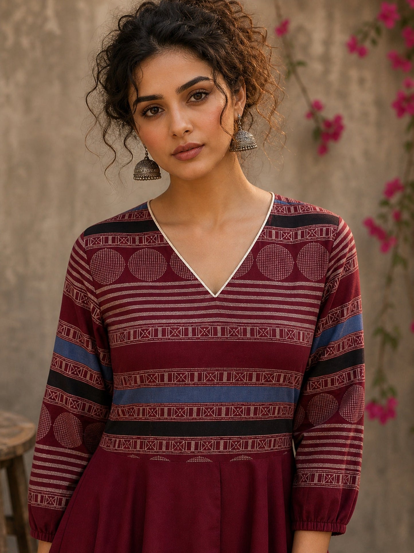 Bold and playful maroon hand block print peplum top with beige geometric motifs and subtle blue accents for effortlessly chic everyday style.