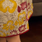 Elegant cream and maroon Madhubani dress featuring sophisticated wavy pintuck flap detailing.