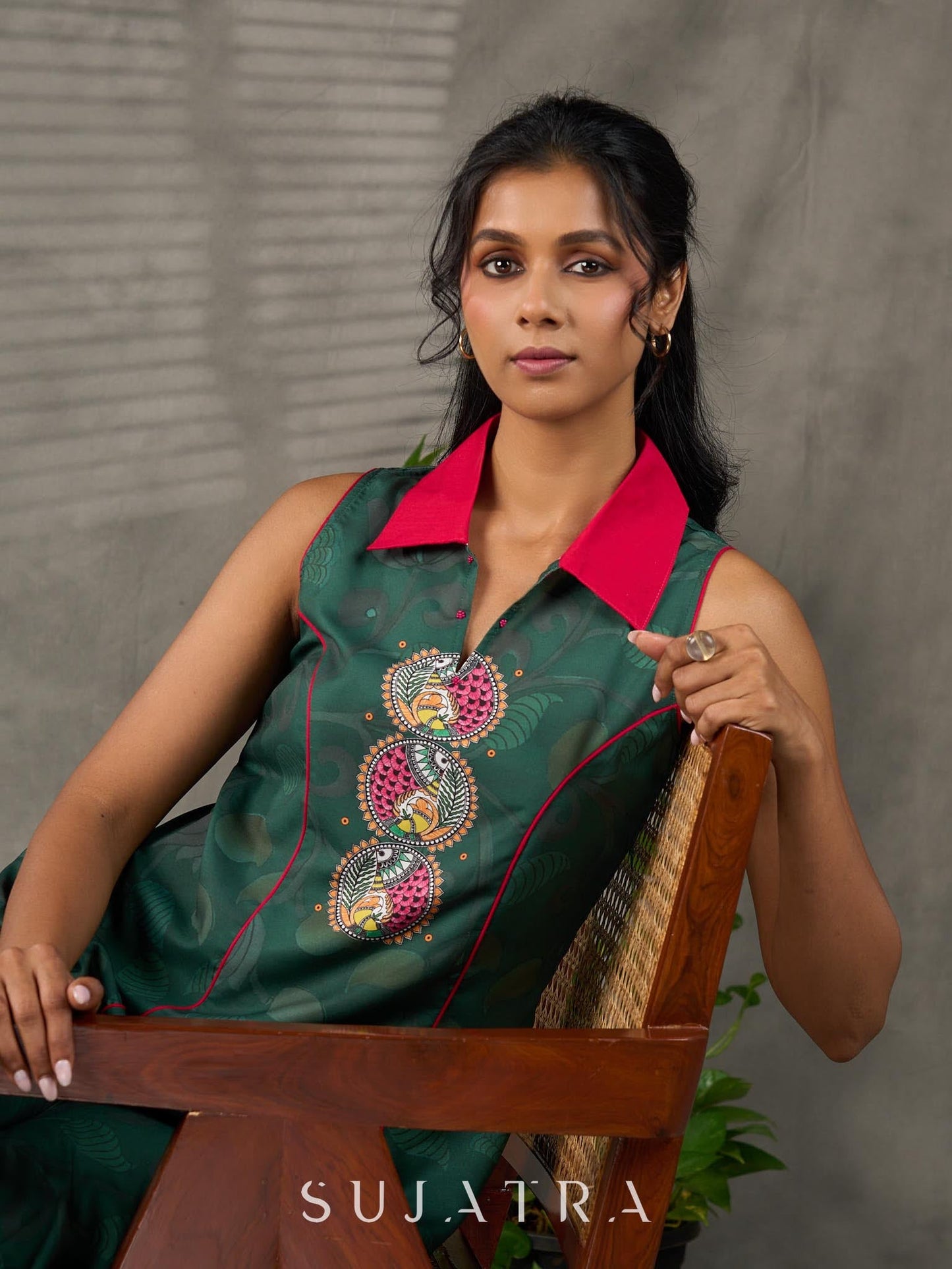 Bottle green Madhubani printed dress with vibrant magenta accents.