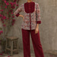 Elegant maroon floral top with intricate maroon pleats, high neckline, covered buttons, and coordinating sleeve cuffs.