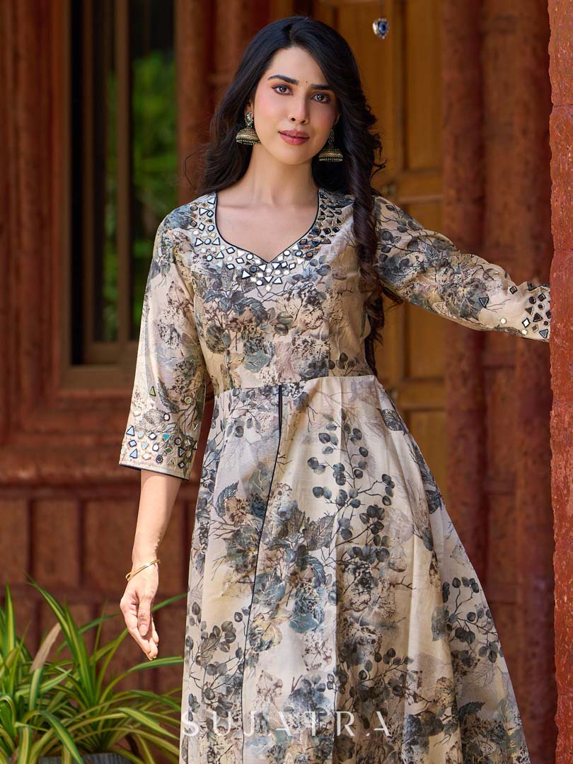 Elegant black–white floral kurta featuring a graceful bias silhouette, intricate mirror embroidery on the neck and sleeves, and a sweetheart neckline.