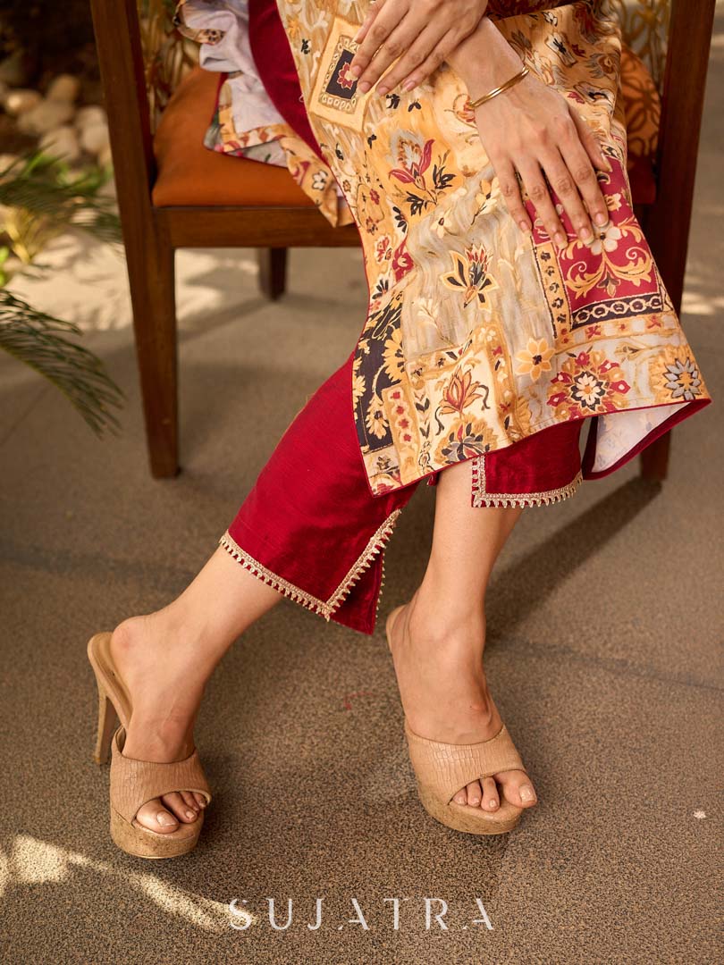Graceful cream all-over printed kurta adorned with an overlapping maroon zardozi-embroidered neckline and bold maroon detailing.