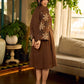 Brown block print dress with floral block printed flared sleeves, black tie-up neckline, and contrast black accents for an effortless, elegant everyday look.