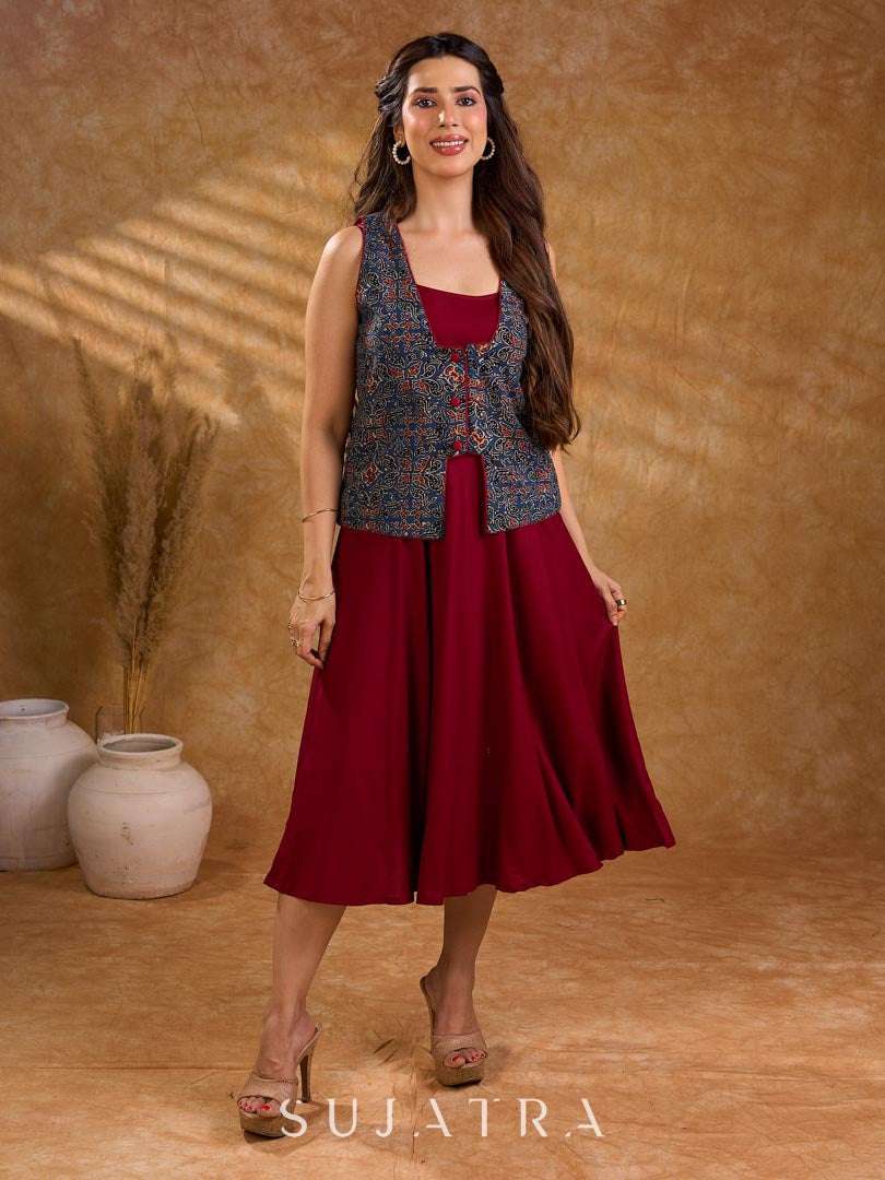 Handcrafted Ajrakh sleeveless jacket featuring front flaps, maroon detailing, breathable fabric, and a contemporary ethnic fusion appeal.