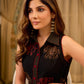 Statement black sleeveless shirt dress showcasing elephant-inspired prints and polka dots, highlighted with maroon accents.