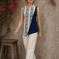 Contemporary off white and navy hand block print top featuring striking geometric motifs, an asymmetric layered silhouette, and effortless elegance