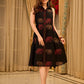 Statement black sleeveless shirt dress showcasing elephant-inspired prints and polka dots, highlighted with maroon accents.