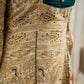 Artisanal beige Madhubani dress featuring intricate motifs, a contrasting green yoke, and refined accents.
