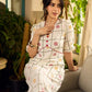 Soft off-white block printed rayon dress with intricate all-over hand block printed checks and florals, a gently gathered yoke, and rich red accents for a refined, elegant everyday look.