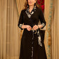 Chic black overlapping blazer-style wrap dress featuring printed black-and-white collar, cuffs, tie detail, and subtle accents