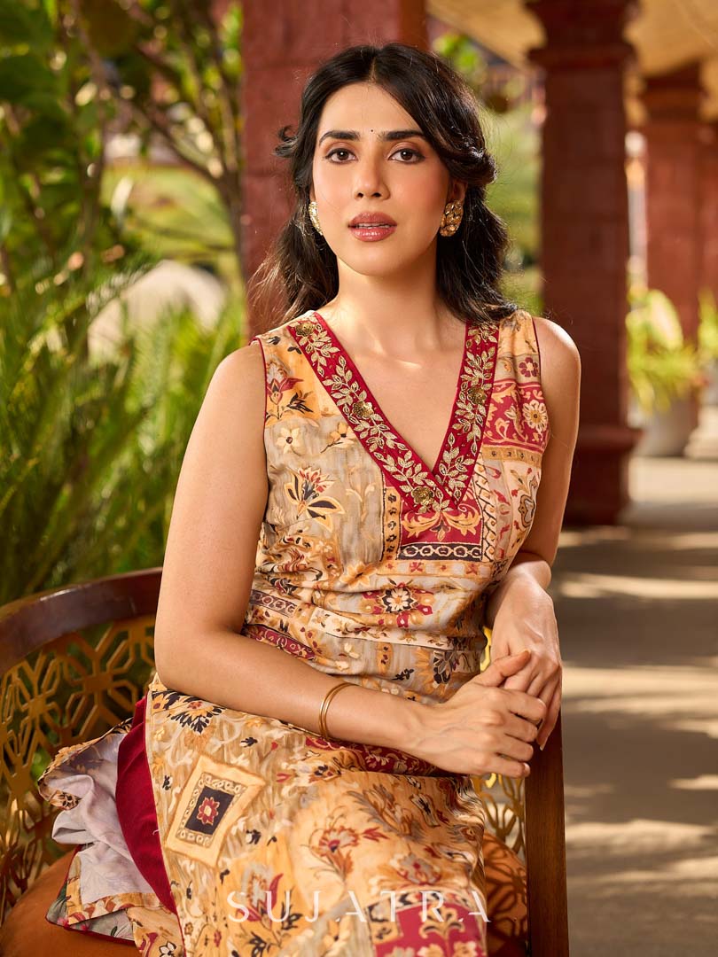 Graceful cream all-over printed kurta adorned with an overlapping maroon zardozi-embroidered neckline and bold maroon detailing.
