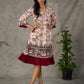 Beige traditional printed dress with rich maroon accents.