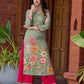 Soft green printed kurta with vibrant floral motifs, highlighted with hand embroidery and bright magenta accents.
