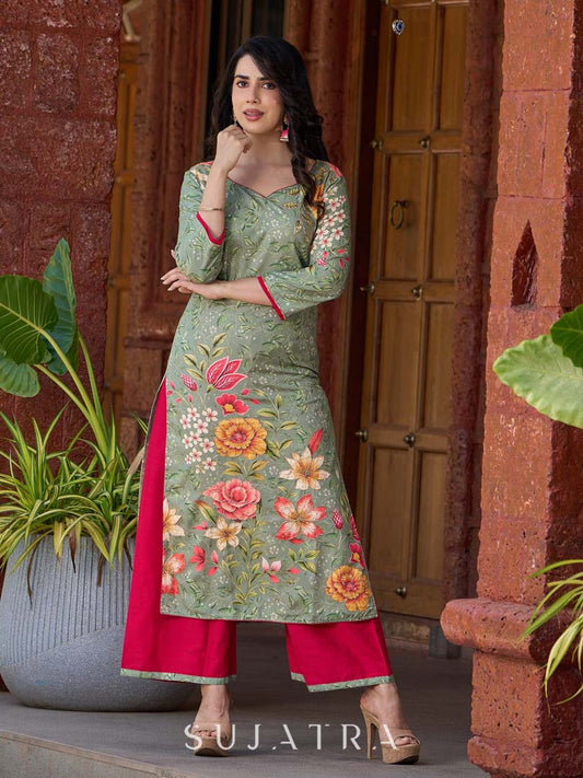 Soft green printed kurta with vibrant floral motifs, highlighted with hand embroidery and bright magenta accents.