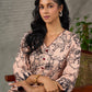 Beige traditional printed dress with rich maroon accents.