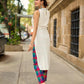 Pristine Off-White Sleeveless Halter Neck Kurta with Vibrant Multicolor Buttons & Hem Trim