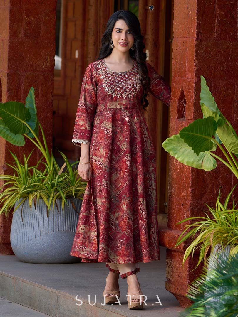 Exquisite deep maroon printed kurta with a graceful bias silhouette, intricate handwork on the yoke, and scalloped sleeve detailing.