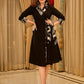Chic black overlapping blazer-style wrap dress featuring printed black-and-white collar, cuffs, tie detail, and subtle accents