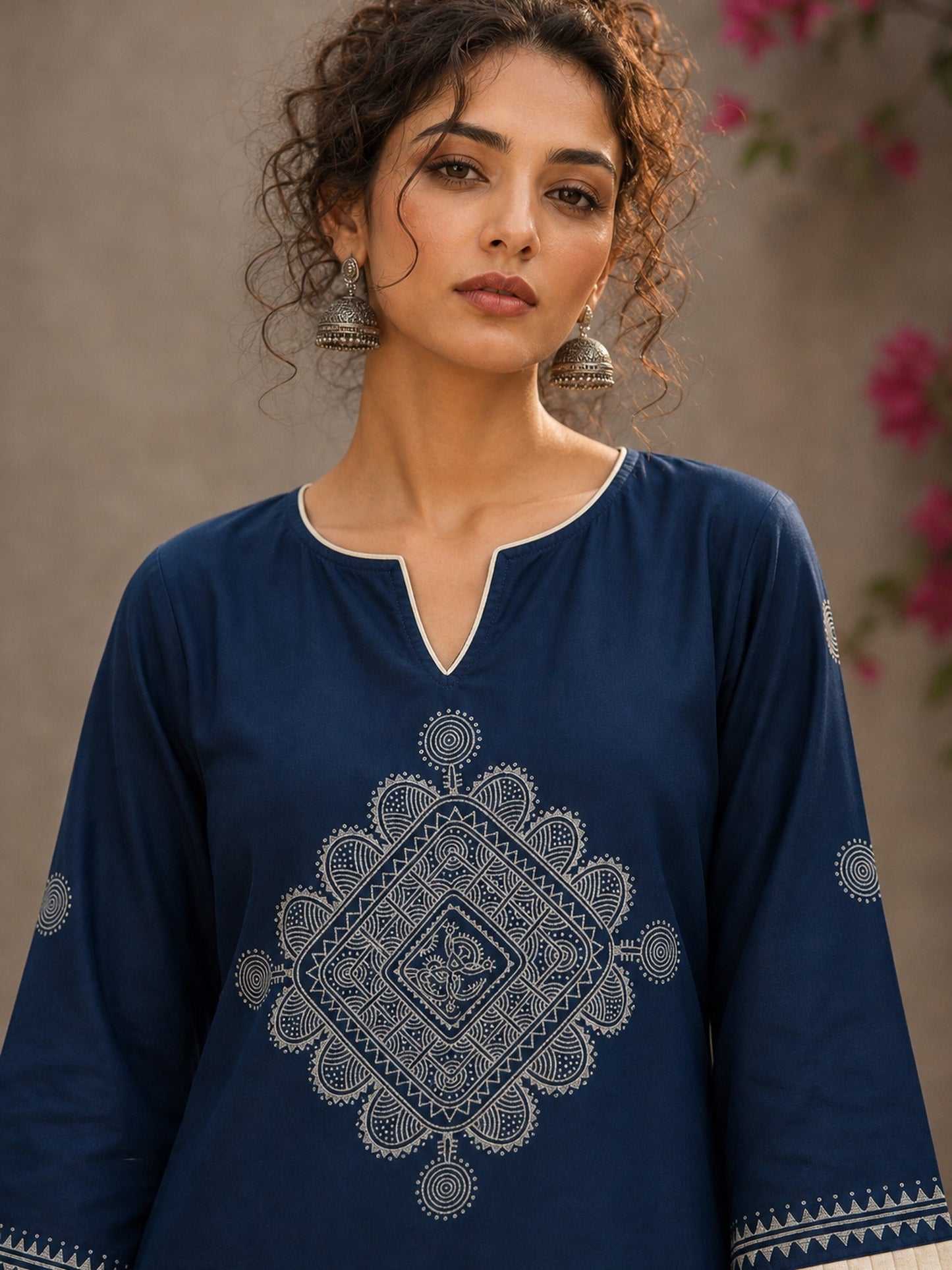 Captivating navy top adorned with a bold, rhythmic block print design, pleated sleeve detailing, and a versatile cut.